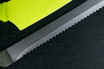 Sharpener for knives with a knife on a dark background.