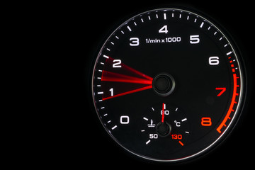 Fototapeta premium Close up shot of a speedometer in a car. Car dashboard. Dashboard details with indication lamps.Car instrument panel. Dashboard with speedometer, tachometer, odometer. Car detailing. Modern interior