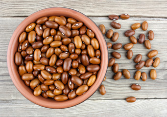 Haricot beans in bowl on wooden background