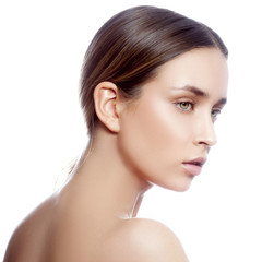 Attractive fashion model girl beauty portrait with nude back. Perfect clean skin, green eyes, natural lips, nude make-up. Isolated. White background. Skincare facial treatment health concept