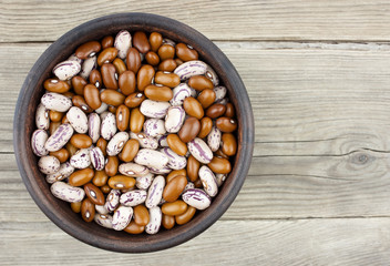 Haricot beans in bowl on wooden background