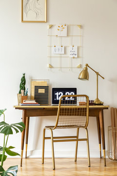 Gold Chair At Desk With Laptop And Lamp In Classic Freelancer's Interior. Real Photo