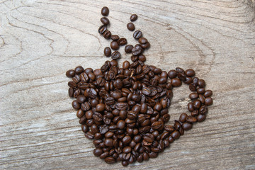 Coffee beans are cups and smoke on old wooden floor.