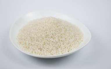 White oval plate with rice on a light background.