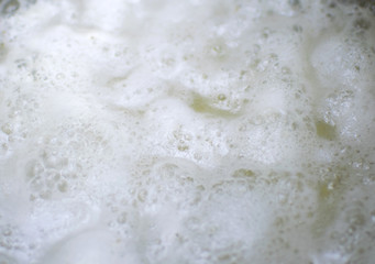 Fototapeta na wymiar A background of foam on top of the water.