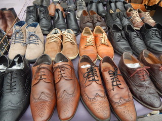 A large selection of second-hand men's leather shoes at the flea market