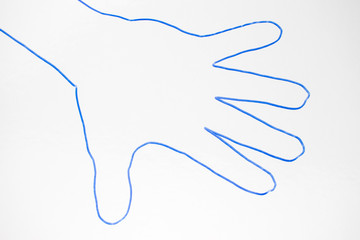 A contour of the human palm with a blue marker on a white background.
