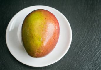 Mango on a white plate.