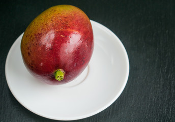 Mango on a white plate.