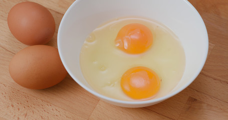 Breaking egg in bowl