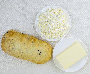 A set of dairy products and bread on a light background.