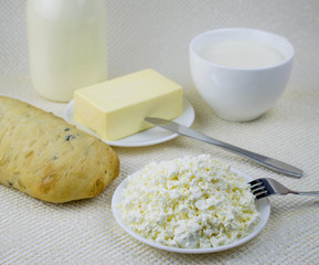 A set of dairy products and bread on a light background.