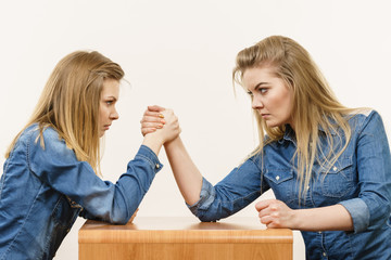 Two women having arm wrestling fight
