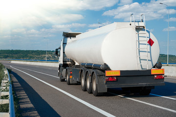 fuel truck rides on road, white blank color, rear view, one object on highway