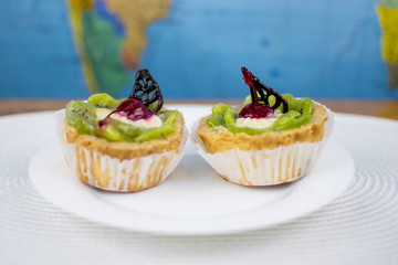 Two cookies - baskets on a white plate.