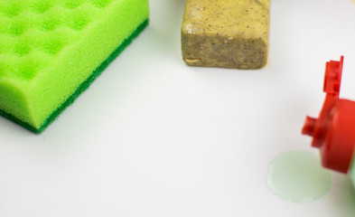 Multicolored foam rubber sponges, soap on a light background.