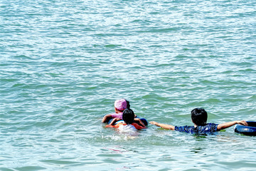 Group of Children Swimming in the Sea