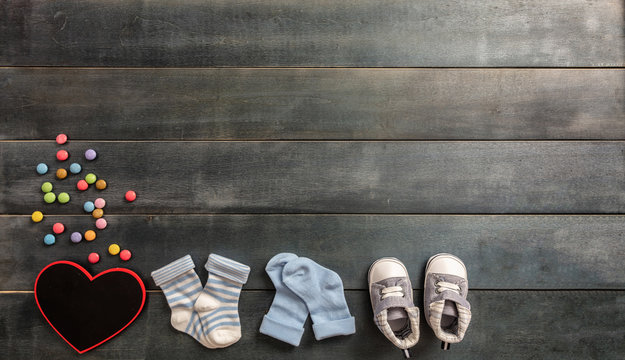 Baby boy shoes and socks on blue wooden background