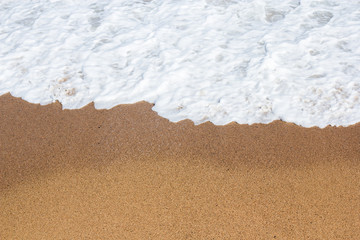 summer background - close up of sandy beach and sea water