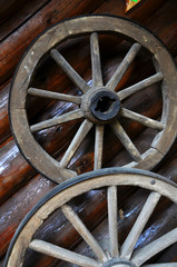 Fototapeta na wymiar Two wooden wheels to the cart