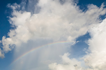 clear sky with clouds and rianbow,blue background