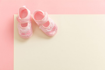 Baby girl shoes on pastel colors background