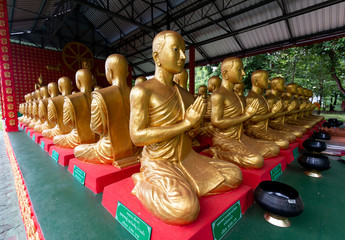 Statue of monks of temple is in the forest in Thailand
