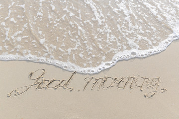 The sea with waves hit the sandy beach in the good morning, with copy space text
