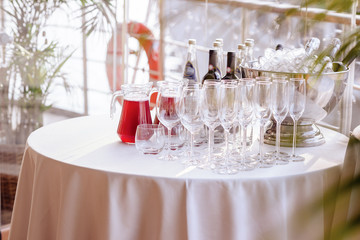 champagne glasses  and bottles on wedding banquet table.