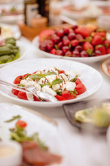 Delicious food ready and decorated.  Banquet table.