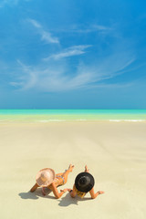 Fototapeta na wymiar Two girls on the tropical beach