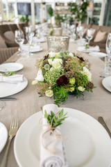Wedding Banquet or gala dinner. The chairs and table for guests, served with cutlery and crockery. Covered with a linen tablecloth runner. party on terrace