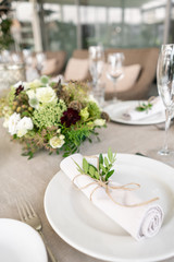 Wedding Banquet or gala dinner. The chairs and table for guests, served with cutlery and crockery. Covered with a linen tablecloth runner. party on terrace