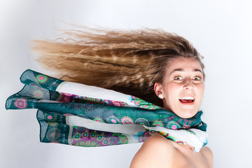 Long hair of woman with scarf blowing in head wind