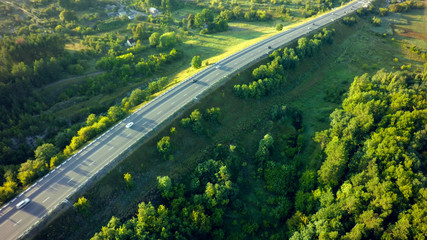 road for cars aerial view from top around green nature