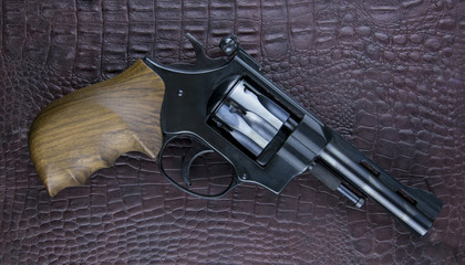 A revolver on a dark background.