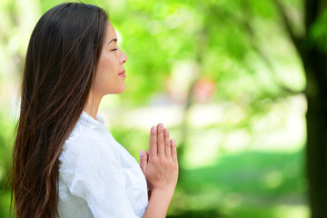 Relaxed Woman Meditating In Park