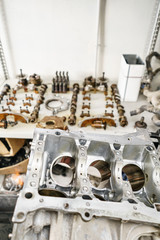The internal combustion engine, disassembled, repair at car service, overhaul. Repair at car service station. Neatly laid out on the table
