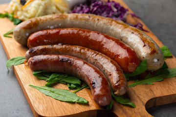 Grilled sausages with mash potatoes on wooden board