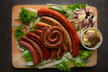 Grilled sausages with mash potatoes on wooden board