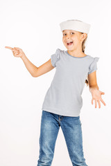 Little girl wearing a sailor costume and looking at the camera on white background.