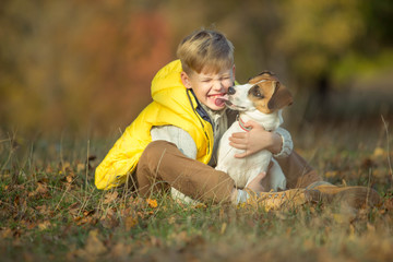 Fototapeta premium Child with dog in autumn 