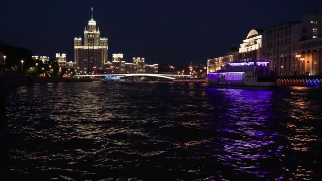 4k video. The boat sails on the Moscow river against the backdrop of the night city.