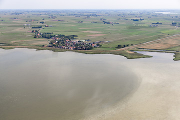Aerial view Dutch village Gaast in Friesland at lake IJsselmeer with shallow water