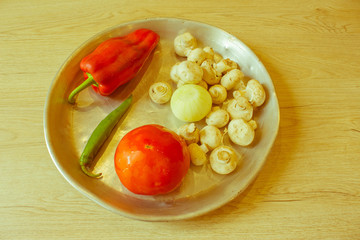 a kitchen concept cooking, culinary, healthy lifestyle. Mushrooms, onion, tomatoes, pepper