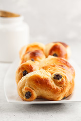 Traditional Swedish saffron buns lussekatt, white background.