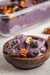 Vegan blackberry ice cream with pecan and coconut cream.