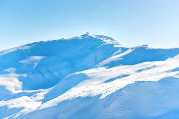 Range of mountains peaks in snow. Winter landscape