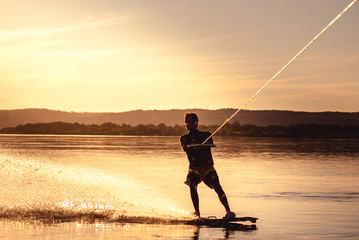 Wakeboarding. Athlete silhouette with splash of water