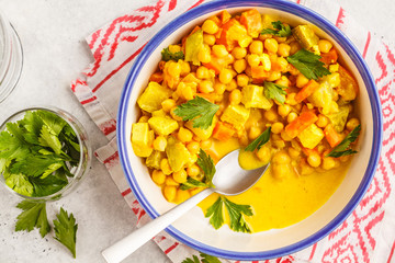 Vegan chickpea vegetables with coconut milk and cilantro, top view.